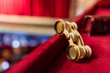 Theatrical binoculars that lie on the red velvet box