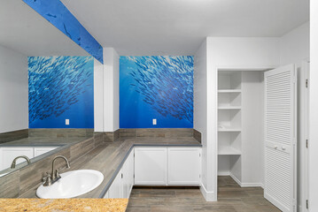 Bathroom with Ocean and fish mural wallpaper. © Monteleone