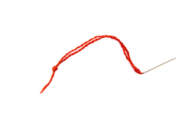 Red thread isolate on white background. Selective focus. Old.