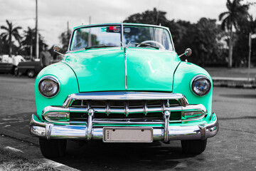 colorkey of turquoise vintage car on the street of havana cuba