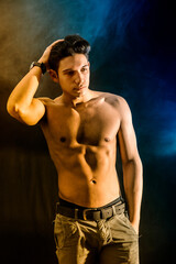 Fototapeta premium Shirtless attractive young man looking at camera in studio