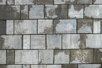 Gray paving stones road. Paving surface road. Texture made of big gray cement bricks background