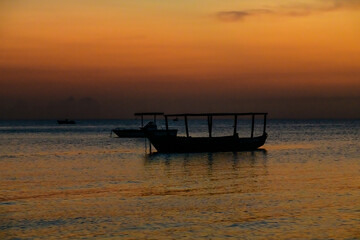Traditional tourist boat at the Indian ocean when sunset. Zanzibar, Tanzania