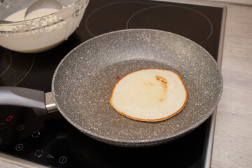 Making pancakes on frying pan.