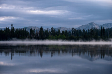 Fototapeta na wymiar Moody Blue Morning Light with Fog Over Laurel Lake