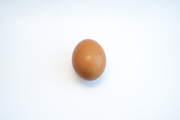 Single brown chicken egg isolated on white background. Food and cooking ingredient concept. 