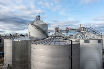 Industrial storage or silo tanks in a row with copy space above