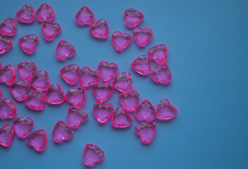 Pink glass hearts, a symbol of love, valentines for Valentine's day. The tradition of making gifts and surprises for the holiday. Banner, postcard, copy space