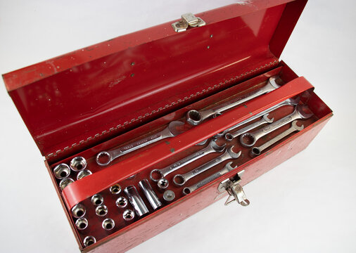 Old red retro handyman toolbox on white background