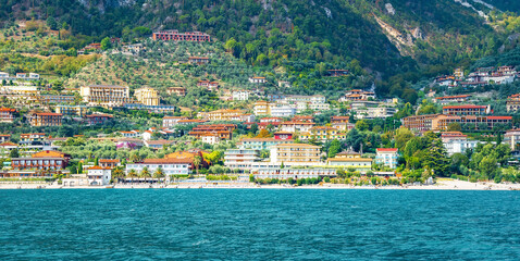 Limone Sul Garda, Italy - September 27, 2022: Village of Limone at Lake Garda, Lombardy, Italy. Colorful houses of Limone village. View from the ship.
