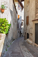 Old narrown streets of Italian villages. Urban scenery. Malcesine, Garda lake, Veneto region, Italy.