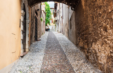 Old narrown streets of Italian villages. Urban scenery. Malcesine, Garda lake, Veneto region, Italy.