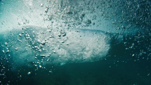 Surfer rides the wave. Young man surfs the ocean wave in the Maldives and tries to get barrelled