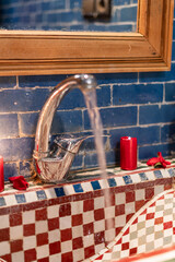 Silver water tap inside a luxury traditional bathroom inside a Riad in the Medina of Fez