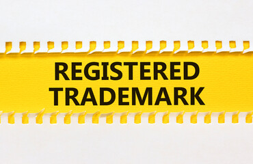 Obraz premium Registered trademark symbol. Concept word Registered trademark on yellow and white paper. Beautiful yellow and white background. Business and registered trademark concept. Copy space.