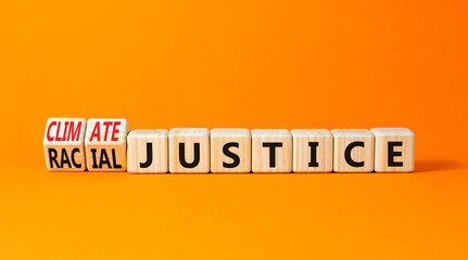 Climate or racial justice symbol. Concept words Climate justice Racial justice on wooden cubes. Beautiful orange table orange background. Ecological climate or racial justice concept. Copy space.
