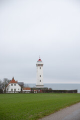 Fototapeta na wymiar The beautiful white lighthouse at Helnæs in Denmark