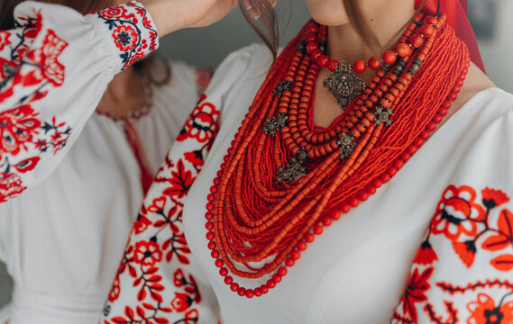 Ukrainian woman in embroidery vyshyvanka dress and ancient coral beads. Traditional necklace and costume of Ukraine.