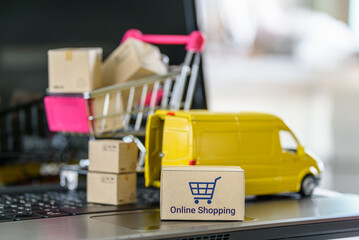 Online shopping, logistics, supply chain and shipment service, e-commerce concept : Boxes of goods, a shopping cart, delivery van on a laptop, depicting buyers place order or make purchases online.