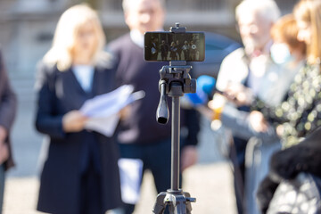 Filming whistleblower holding confidential document at media event or news conference with...
