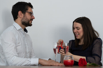 young woman opening a gift from her husband