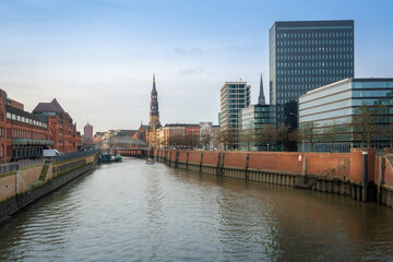 Fototapeta na wymiar Zollkanal canal at Speicherstadt and Hamburg skyline with St. Catherine Church - Hamburg, Germany