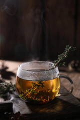 Tea with thyme in a transparent mug