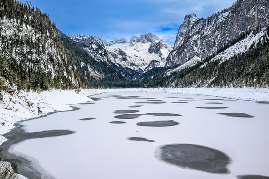 The frozen Gosausee with the snowy Dachstein peak in the background 