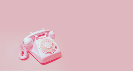 Pink  rotary telephone on light pink background. Space for text on the right
