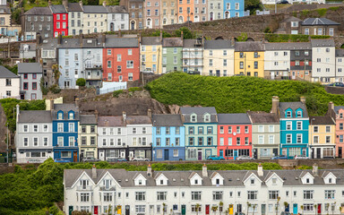 Fototapeta premium Cobh Waterfront from the Ship. Panoramic exposure done from a ship showing the beautifull houses and Cobh Cathedral.