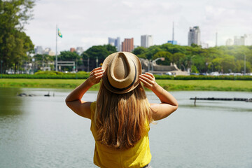 Tourism in Sao Paulo, Brazil. Back view of traveler girl enjoying skyline of Sao Paulo metropolis...