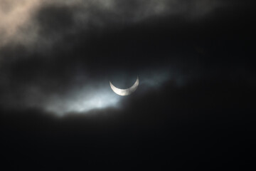 Obraz na płótnie Canvas partial sun eclipse with mysterios clouds