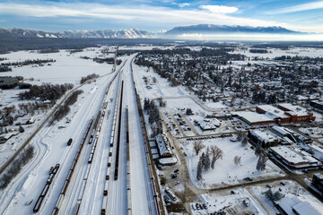 Aerial view of Whitefish, Montana on a cloudy winter day with the Rockies n the background