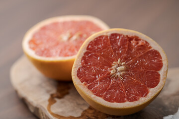 Fototapeta na wymiar Ripe grapefruit on wood board closeup
