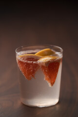 Grapefruit lemonade in tumbler glass on wood table