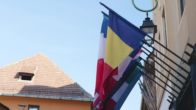 Romanian flag waving in Brasov, Transylvania, Romania on a sunny day