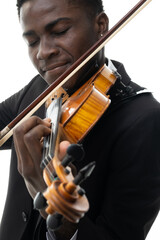 African american man in suit plays the violin in studio against white background. Closeup