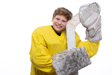 A hockey player in uniform with equipment over a white background. The athlete, child, sport, action concept