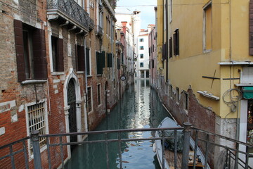 Fototapeta na wymiar Venitian canal between colorful buildings in Venice, Italy