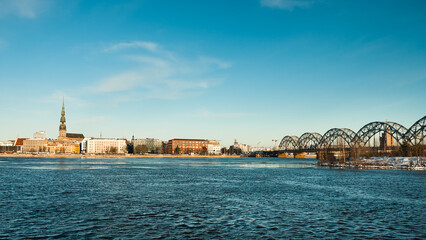Fototapeta na wymiar riga, panorama of the city, in the background the blue sky in the foreground is the river