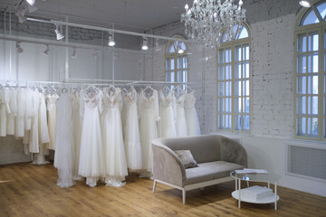 Fototapeta na wymiar Collection of wedding dresses in the shop