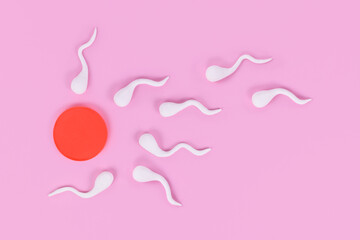 Abstract sperm cells swimming towards egg cell on pink background - obrazy, fototapety, plakaty