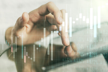 Abstract creative financial graph with finger clicks on a digital tablet on background, forex and investment concept. Multiexposure