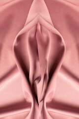 Pink soft fabric shaped as female genital organs, vulva and labia, vagina concept