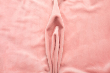 Pink soft fabric shaped as female genital organs, vulva and labia, vagina concept