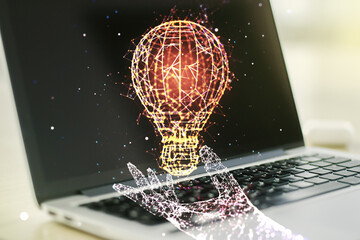 Obraz na płótnie Canvas Double exposure of creative light bulb hologram on laptop background, research and development concept