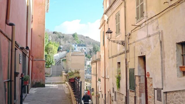 Old narrow streets of medieval countryside city of Italy, ancient buildings facade, vintage street lamps and window shutters creating special medieval atmosphere in the city, culture and architecture