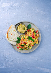 Traditional Moroccan vegetable couscous with pita bread and hummus served as top view on a Nordic...