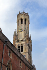 Fototapeta na wymiar The Belfry of Bruges, a medieval bell tower in the center of Bruges, Belgium. One of the city's most prominent symbols. The belfry was added to the market square around 1240.