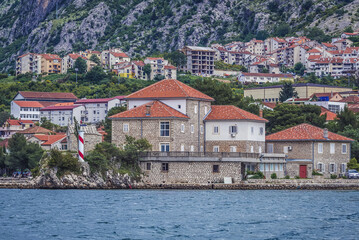 Fototapeta na wymiar Church of St Elijah and building of Institute of Marine Biology in Dobrota, Montenegro